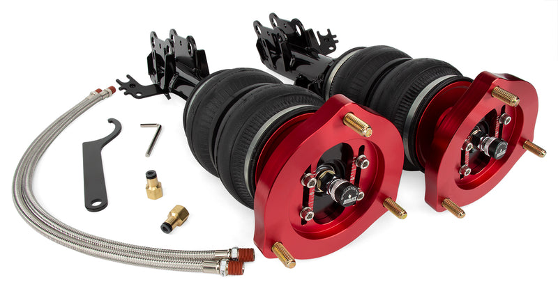 A pair of Air Lift Performance red accented monotube struts with double bellows progressive rate air springs with bolt-in camber plates and powdercoated gloss black steel mounting brackets.  A pair of braided stainless steel leader hoses and fittings.  Air suspension kit