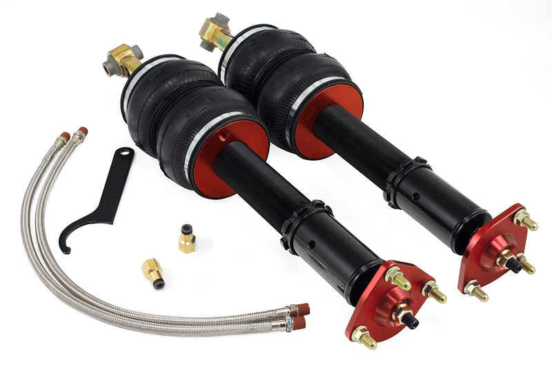 A pair of Air Lift Performance red accented monotube struts with compact double bellows progressive rate air springs along with stainless steel leader hoses and fittings. Air suspension kit part