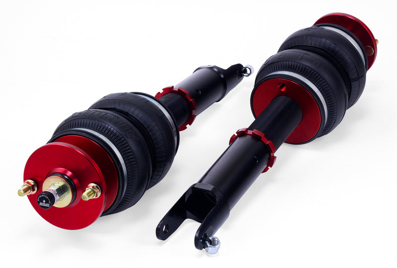 A pair of Air Lift Performance red accented air-over monotube struts with double bellows-style progressive rate air springs. Air suspension kit part