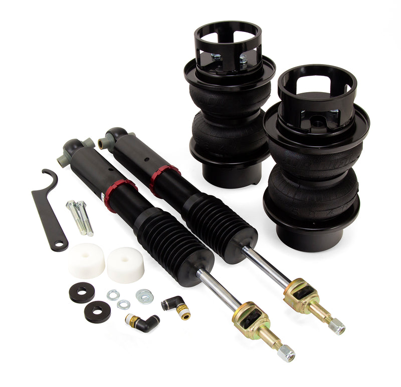 A pair of Air Lift Performance red accented high performance monotube shocks, compact double bellows progressive rate air springs with roll plates and fittings. Air suspension kit part
