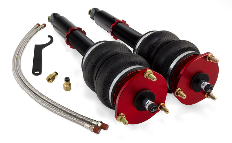 A pair of Air Lift Performance red accented monotube struts with compact double bellows progressive rate air springs along with stainless steel leader hoses and fittings. Air suspension kit part