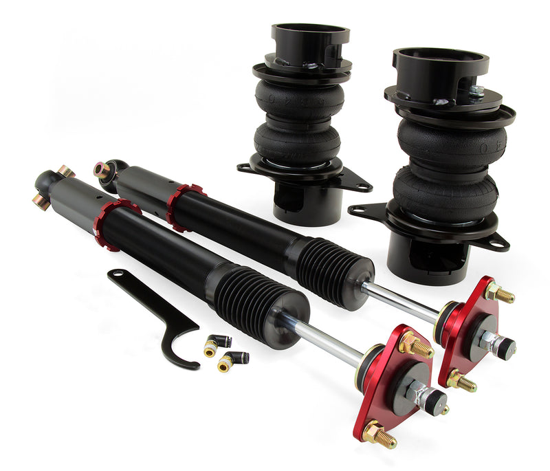 A pair of Air Lift Performance red accented monotube struts with double bellows progressive rate air springs, roll plates and powdercoated gloss black steel brackets, and fittings. Air suspension kit part