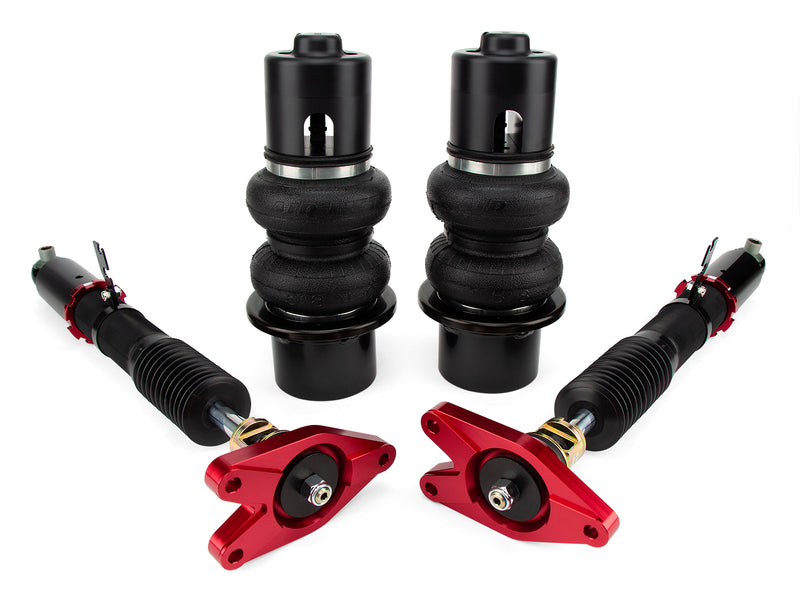 A pair of Air Lift Performance red accented monotube shocks, double bellows progressive rate air springs with anodized aluminum accents along with powdercoated gloss black steel brackets. Air suspension kit part