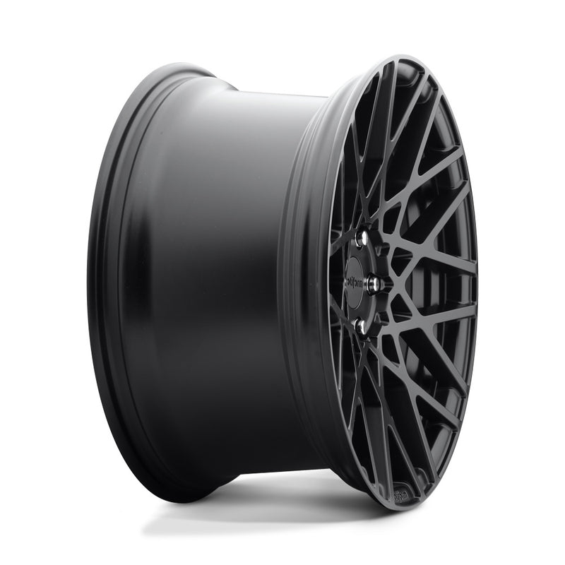 Side view of a Rotiform BLQ monoblock cast aluminum 10 spoke mesh pattern automotive wheel in a matte black finish with an embossed Rotiform logo on the lip and a black Rotiform logo center cap.