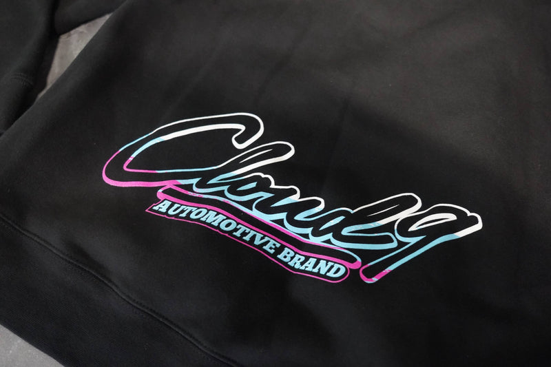 Close up of the rear of a black hoodie showing the full color Cloud 9 Automotive Brand logo to the bottom edge.