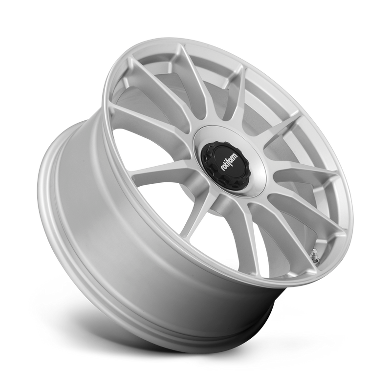 Tilted side view of a  Rotiform DTM monoblock cast aluminum 11 spoke automotive wheel in a silver finish with a Rotiform black center cap.