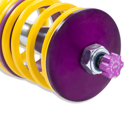 Close up view of spring end of coilover showing purple rebound adjustment knob.