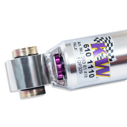 Close up of end of chrome coilover showing purple adjustment knob.