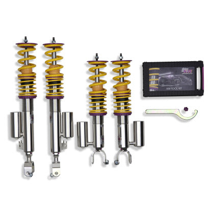 4 vehicle suspension chrome body coilovers with yellow springs and purple accented fittings, 1 coilover adjustment tool and storage box.