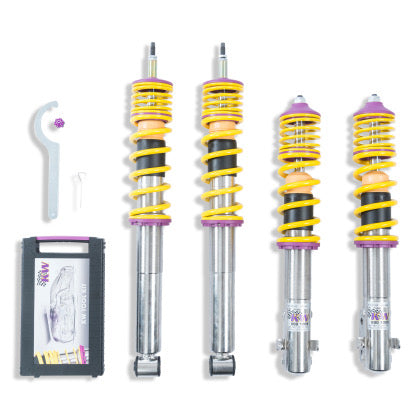 4 vehicle suspension chrome body coilovers with yellow springs and purple accented fittings, 1 coilover adjustment tool and storage box.