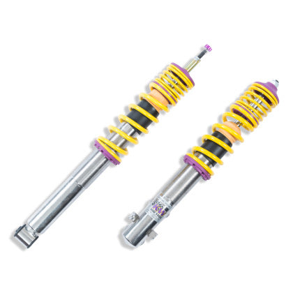 2 vehicle suspension chrome body coilovers with yellow springs and purple accented fittings.