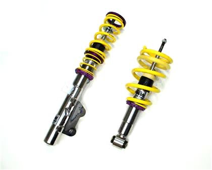 2 assembled vehicle suspension chrome coilovers with yellow springs.