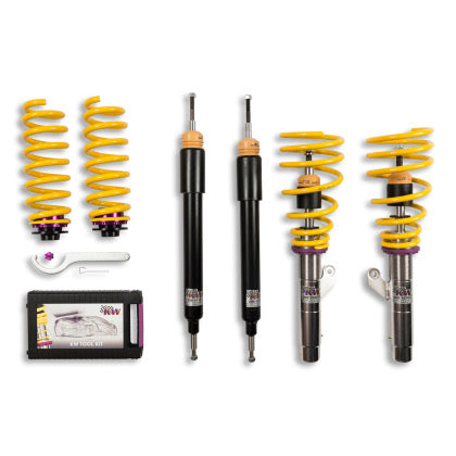 2 assembled vehicle suspension coilovers with yellow springs, 2 black coilover bodies and 2 yellow springs, installation tool and storage box.