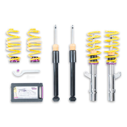 2 vehicle suspension chrome coilovers with yellow springs and purple fitting along with 2 black coilovers, 2 yellow springs with purple accented end fittings, 1 coilover adjustment tool and storage box.