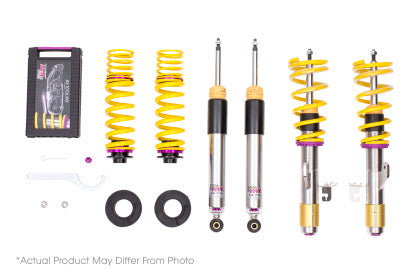 2 assembled chrome body coilovers with yellow springs and purple accented fittings, 2 chrome body coilovers and 2 yellow springs with purple and black fittings, 1 coilover adjustment tool and storage box.