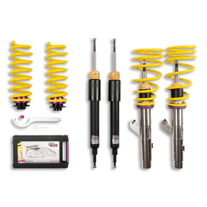 2 assembled vehicle suspension chrome coilovers with yellow springs, 2 black coilover bodies and 2 yellow springs with end fittings and coilover installation tool with storage box.