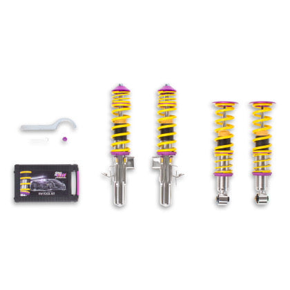 4 assembled vehicle suspension chrome coilovers with yellow springs and purple fittings with adjustment tool and storage box.