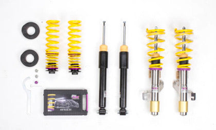 2 assembled vehicle suspension chrome coilovers with yellow springs, 2 black coilover bodies and 2 yellow springs with end fittings, coilover adjustment tool and storage box.
