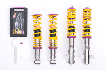 4 vehicle suspension chrome body coilovers with yellow springs and purple fittings, 1 coilover adjustment tool and storage box.
