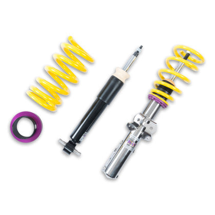 1 chrome vehicle suspension coilover with yellow spring, 1 black body coilover and 1 yellow spring with purple spring fitting.