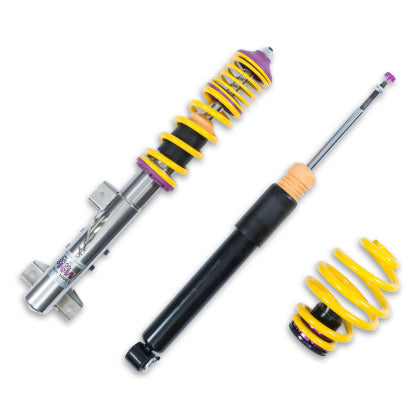 1 vehicle suspension chrome coilover with yellow spring and purple fitments, 1 black coilover and 1 yellow spring.