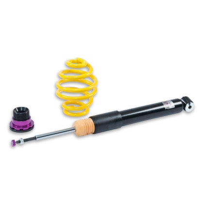 1 black vehicle suspension coilover and 1 yellow spring with black and purple accented fitment.