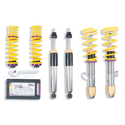 2 fully assembed vehicle suspension chrome body coilvoers with yellow springsm 2 chrome coilover bodies and 2 yeallow springs with purple accented fittings, 1 coilover adjustment tool and storage box.