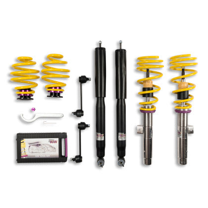 2 veehicle suspension chrome body coilovers with yellow springs and purple accnted fittings, 2 black body coilovers, 2 yellow springs with purple fittings, 2 black end links, 1 coilover adjustment tool and storage box.