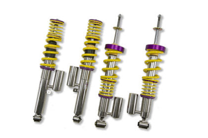 4 assembled vehicle suspension chrome body coilovers with yellow springs and purple accented fittings.