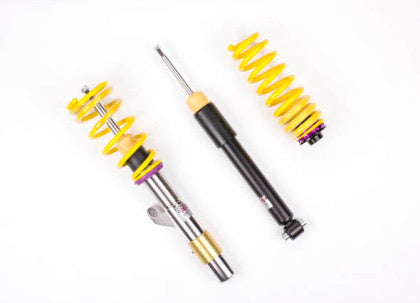 1 vehicle suspension chrome body coilover with yellow spring and purple fitting, 1 black body coilover and 1 yellow spring with purple and black end fitting.