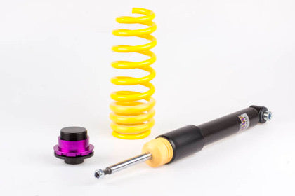 1 vehicle suspension black body coilover an 1 yellow spring and 1 black and purple fitting.
