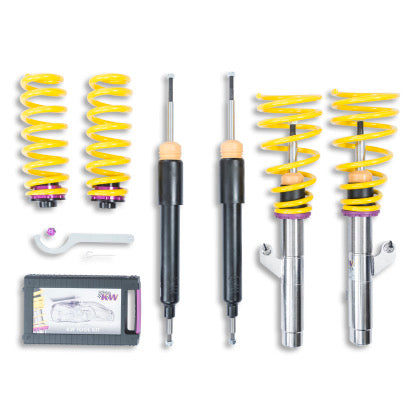 2 vehicle suspension chrome body coilovers with yellow springs and purple accented fittings, 2 black body coilovers, 2 yellow springs with 2 purple end fitts, 1 coilover adjustmeent tool and storage box.