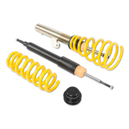 Black coilover strut in threaded sleeve with spring attached along with a single black strut and a single lowering spring