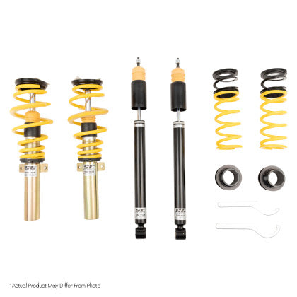 Two assembled coilovers, two black coilover struts and yellow springs