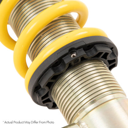 Close up of yellow lowering spring on threaded strut sleeve