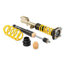 One assembled vehicle suspension coilover and one unsleeved black strut and one yellow lowering spring