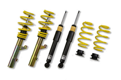 Two assembled vehicle suspension coilovers, two unsleeved coilover black struts and two yellow coilover springs