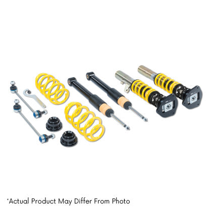 Vehicle suspension coilover kit showing two assembled black and yellow coilivers, two black coilover struts and two lowering springs along with adjustment dials and end links