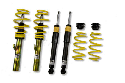 Two assembled vehicle suspension adjustable coilovers, two unsleeved coilover struts and two yellow coilovers springs with end fittings