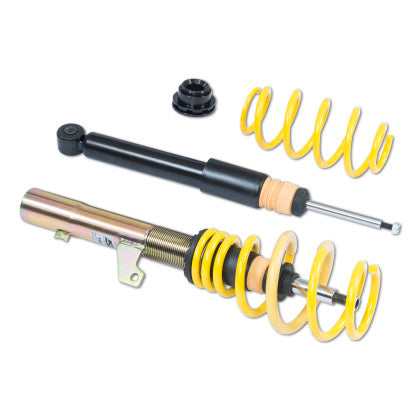 One assembled vehicle suspension coilover, one unsleeved coilover black strut and one yellow spring with end fitting