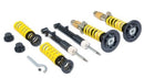 Vehicle suspension adjustable coilover kit showing two assembled and two unassembled coilvers