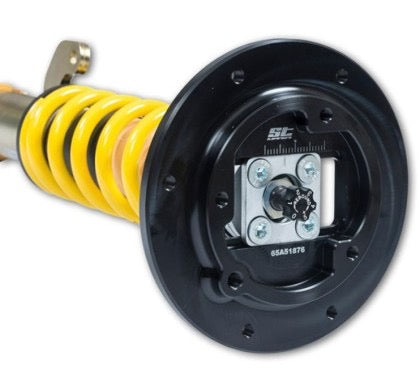 Adjustment knob and plate at the end of a vehicle suspension coilover