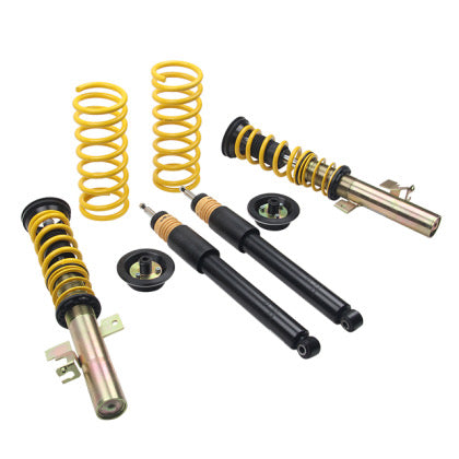 Two adjustable vehicle suspension coilovers, two unsleeved balack struts and two yellow coilover springs with fitments.