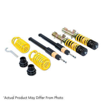 Two assembled vehicle suspension adjustable coilovers, two unsleeved coilover black struts and two yellow coilover springs with tool and fittings