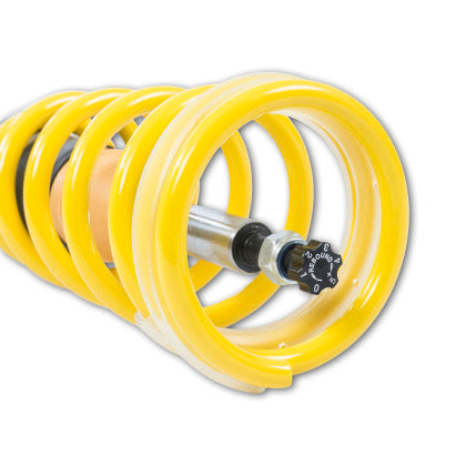 Yellow lowering spring and strut end showing rebound adjustment knob