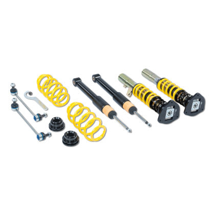 Two assembled vehicle suspension adjsutable coilovers, two unsleeved coilover black struts and two yellow coilover springs with endlinks and adjustment dials
