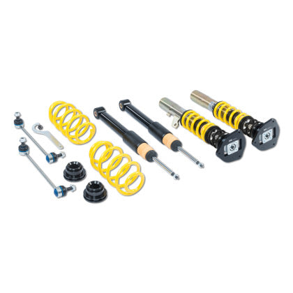 Two vehicle suspension adjustable coilovers, two unsleeved coilover struts and two yellow coilover springs with endlinks and fittings