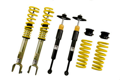 Two assembled vehicle suspension coilovers and two unsleeved black coilover struts along with two coilover springs