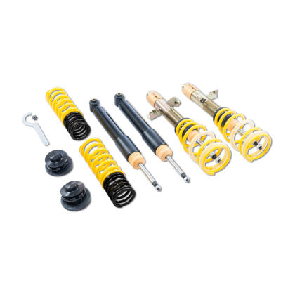 Vehicle suspension coilover kit showing two assembled and two unassembled coilovers