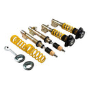 Two assembled vehicle suspension coilovers, two sleeved coilover struts and two yellow coilover springs